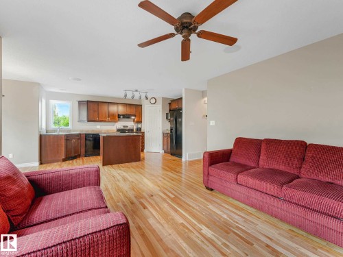 Open-concept living space featuring wood-finish flooring, a ceiling fan, and recessed lighting - 1325 Latta Crescent, Edmonton, AB - Indoor Photo Showing Living Room