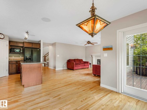 Spacious open-concept interior featuring light wood-finish flooring - 1325 Latta Crescent, Edmonton, AB - Indoor