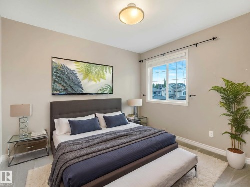 Bedroom featuring light neutral walls, a large window, and light-toned flooring - 1325 Latta Crescent, Edmonton, AB - Indoor Photo Showing Bedroom