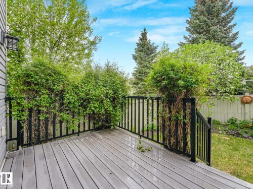 Spacious outdoor deck featuring composite decking, black metal railings, and integrated wall lighting - 1325 Latta Crescent, Edmonton, AB - Outdoor With Deck Patio Veranda