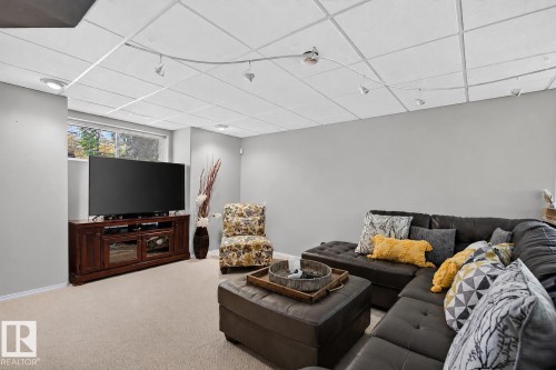 Finished lower level with neutral carpeting, recessed lighting, track lighting, and a visible window - 163 Galland Crescent, Edmonton, AB 