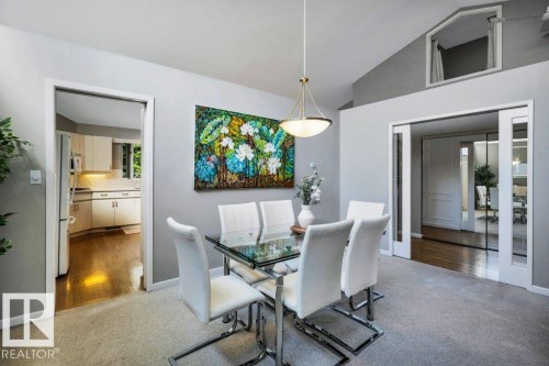 Dining area featuring vaulted ceilings and a brass-finish pendant light fixture - 11742 29 Avenue, Edmonton, AB 