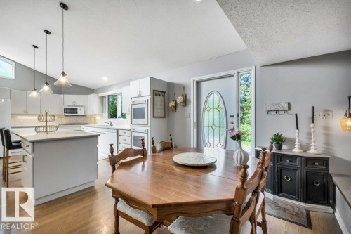 Kitchen with white cabinetry, light countertops, and a full suite of built-in appliances - 11742 29 Avenue, Edmonton, AB 