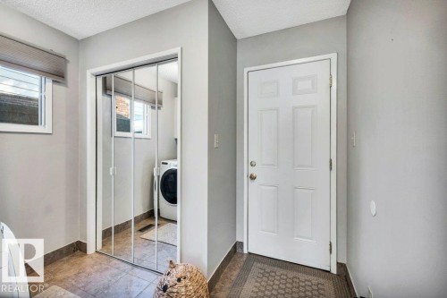 Utility area featuring tile flooring, light gray walls, and white trim - 11742 29 Avenue, Edmonton, AB 