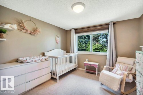 Well-lit room with neutral wall tones and a textured ceiling - 11742 29 Avenue, Edmonton, AB 