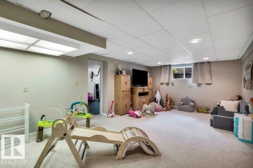 Spacious finished room featuring carpeted flooring, recessed lighting, and a drop ceiling - 11742 29 Avenue, Edmonton, AB 