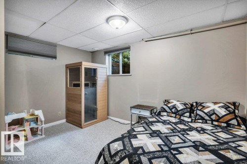 Carpeted room featuring a built-in wood-finish sauna, a single window, and neutral wall tones - 11742 29 Avenue, Edmonton, AB 