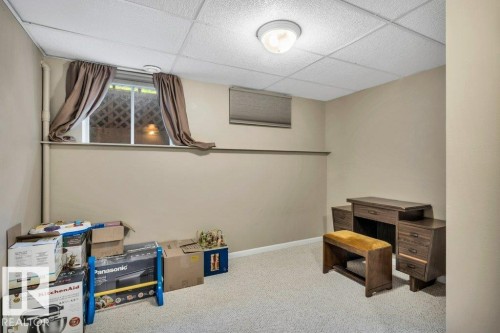 Finished room featuring neutral wall paint, light-colored carpeting, and a drop ceiling with recessed lighting - 11742 29 Avenue, Edmonton, AB 