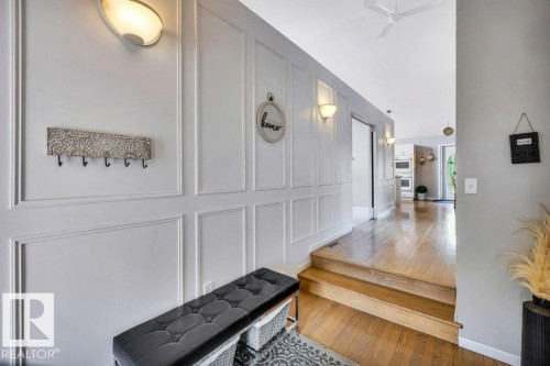 Entryway featuring wainscoting details and wood-finish flooring - 11742 29 Avenue, Edmonton, AB 