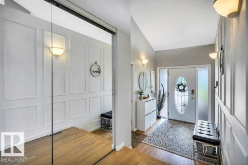Entryway featuring a decorative front door with oval glass insert and sidelights - 11742 29 Avenue, Edmonton, AB 