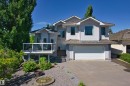 Contemporary residence featuring a light-colored stucco exterior and a shingle roof - 922 Wallbridge Place, Edmonton, AB 