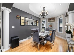 Dining space featuring hardwood flooring, decorative ceiling medallion, and a chandelier - 