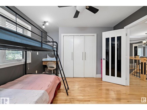 Bedroom with hardwood flooring, track lighting, and a ceiling fan - 9544 154 Street, Edmonton, AB 