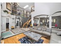 Grand foyer with a curved staircase, hardwood flooring, and decorative tile inlay - 9544 154 Street, Edmonton, AB 