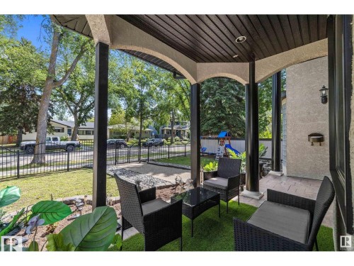 Covered patio featuring an artificial turf flooring, stucco finish, and recessed lighting - 9544 154 Street, Edmonton, AB 