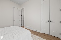 Crisp white walls with warm wood-finish flooring - 