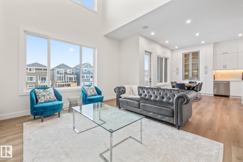 Open-concept living area with high ceilings and large windows - 132 Edgewater Circle, Leduc, AB 