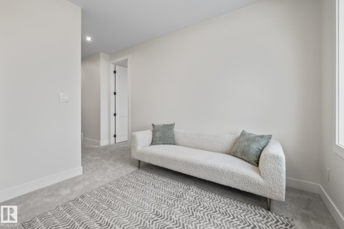 Carpeted room with a white wall finish, recessed lighting, and a window - 132 Edgewater Circle, Leduc, AB 