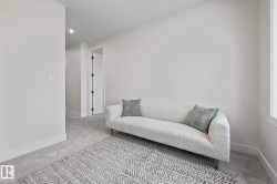 Carpeted room with a white wall finish, recessed lighting, and a window - 