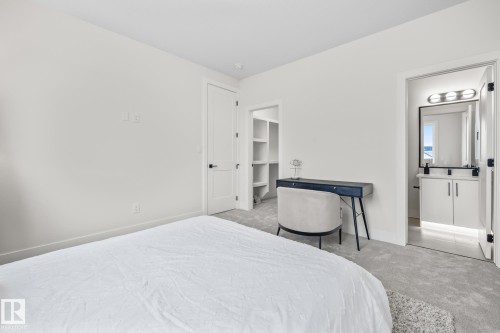 Light gray carpeted bedroom with white walls - 132 Edgewater Circle, Leduc, AB 