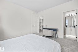 Light gray carpeted bedroom with white walls - 