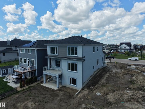 Contemporary two-story residence featuring a combination of light gray stucco and dark gray siding - 132 Edgewater Circle, Leduc, AB 