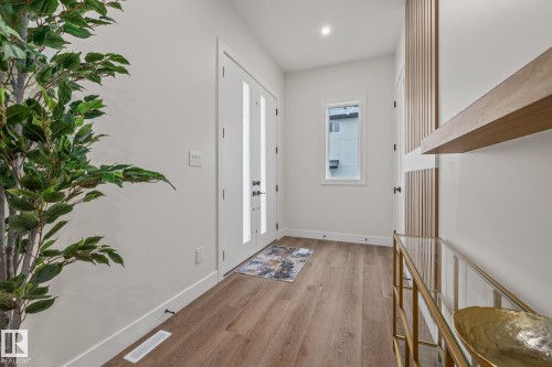 Entryway featuring wood-finish flooring, white baseboards, and a white ceiling with recessed lighting - 132 Edgewater Circle, Leduc, AB 