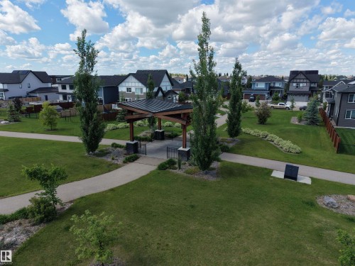 Community greenspace featuring a covered pavilion with a dark metal roof and wood-look support beams - 132 Edgewater Circle, Leduc, AB 