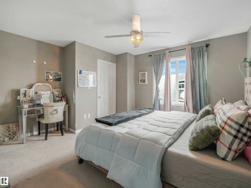 Bright bedroom featuring a double window, ceiling fan with integrated lighting, and neutral wall paint - 44 1140 Chappelle Boulevard, Edmonton, AB 