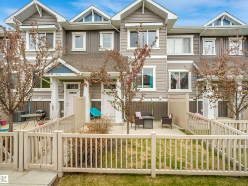 Townhome exterior featuring horizontal siding, a gabled roofline, and multiple windows - 44 1140 Chappelle Boulevard, Edmonton, AB 