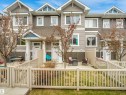 Townhome exterior featuring horizontal siding, a gabled roofline, and multiple windows - 44 1140 Chappelle Boulevard, Edmonton, AB 