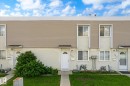 Multi-unit residential facade featuring stucco and horizontal siding - 186 Cornell Crest, Edmonton, AB 