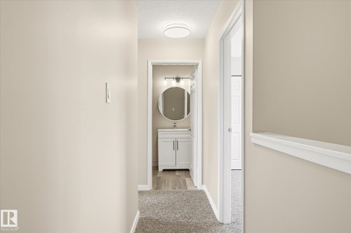 Hallway featuring neutral wall tones, carpet flooring, and a flush mount ceiling light - 186 Cornell Crest, Edmonton, AB 