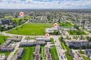 Aerial view showcasing a residential neighborhood with extensive green spaces and multiple buildings - 186 Cornell Crest, Edmonton, AB 