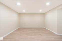 Spacious room featuring wood-finish flooring, recessed lighting, and neutral wall tones - 