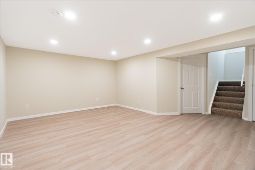 Spacious room featuring light wood-finish flooring, recessed lighting, and neutral wall paint - 186 Cornell Crest, Edmonton, AB 