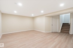 Spacious room featuring light wood-finish flooring, recessed lighting, and neutral wall paint - 