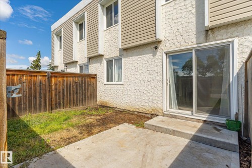 Private concrete patio extending from the property, featuring a sliding glass door entry - 186 Cornell Crest, Edmonton, AB 