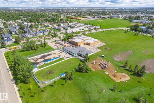 Expansive green space featuring multiple sports fields, an outdoor rink, and a playground area with various equipment - 186 Cornell Crest, Edmonton, AB 