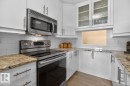 Updated White Kitchen Cabinets with Granite Counter Tops and Stainless Steel Appliances. Pass through window next to your front entrance makes dropping off groceries a breeze! - 602 12303 Jasper Avenue, Edmonton, AB 