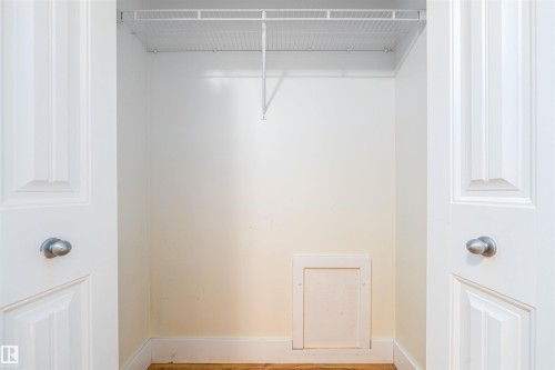 Closet featuring a wire shelving system, light-colored walls, white trim, and wood-finish flooring - 12246 103 Street, Edmonton, AB - Indoor With Storage