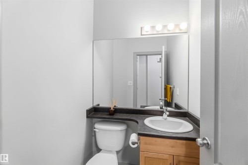 White oval sink with chrome faucet, set into a dark countertop - 3061 Spence Wynd, Edmonton, AB 