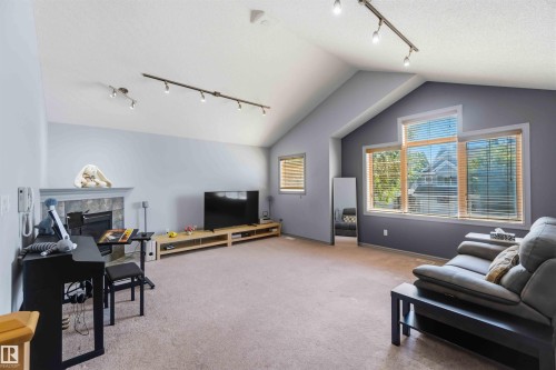 Spacious living area featuring a vaulted ceiling and track lighting - 3061 Spence Wynd, Edmonton, AB 