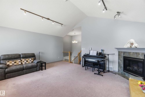 Spacious living area featuring a vaulted ceiling and track lighting - 3061 Spence Wynd, Edmonton, AB 