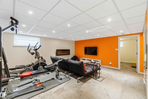 Lower level recreation area featuring neutral tone carpeting and a drop ceiling with recessed lighting - 3061 Spence Wynd, Edmonton, AB 