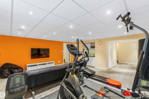 Versatile finished lower level featuring recessed lighting, drop ceiling, and carpeted flooring - 3061 Spence Wynd, Edmonton, AB 