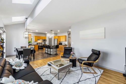 Open-concept living area with hardwood flooring and skylights - 3061 Spence Wynd, Edmonton, AB 