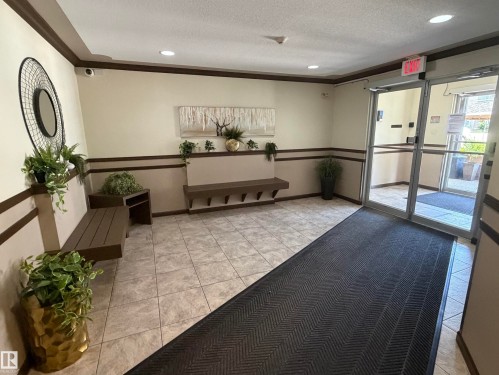 Tile flooring entryway with recessed lighting, glass doors, and two built-in benches - 213 17467 98A Avenue, Edmonton, AB 