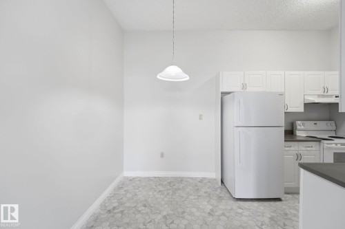 Kitchen and dining area featuring hexagonal tile flooring - 105 11446 40 Avenue Nw, Edmonton, AB 
