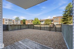 Private outdoor space featuring a wood-plank deck area and a gravel surface - 